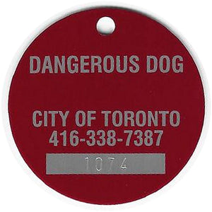 The Original Dangerous Dog tag — back, stamped DANGEROUS DOG / CITY OF TORONTO / 416-338-7387 / serial 1074
